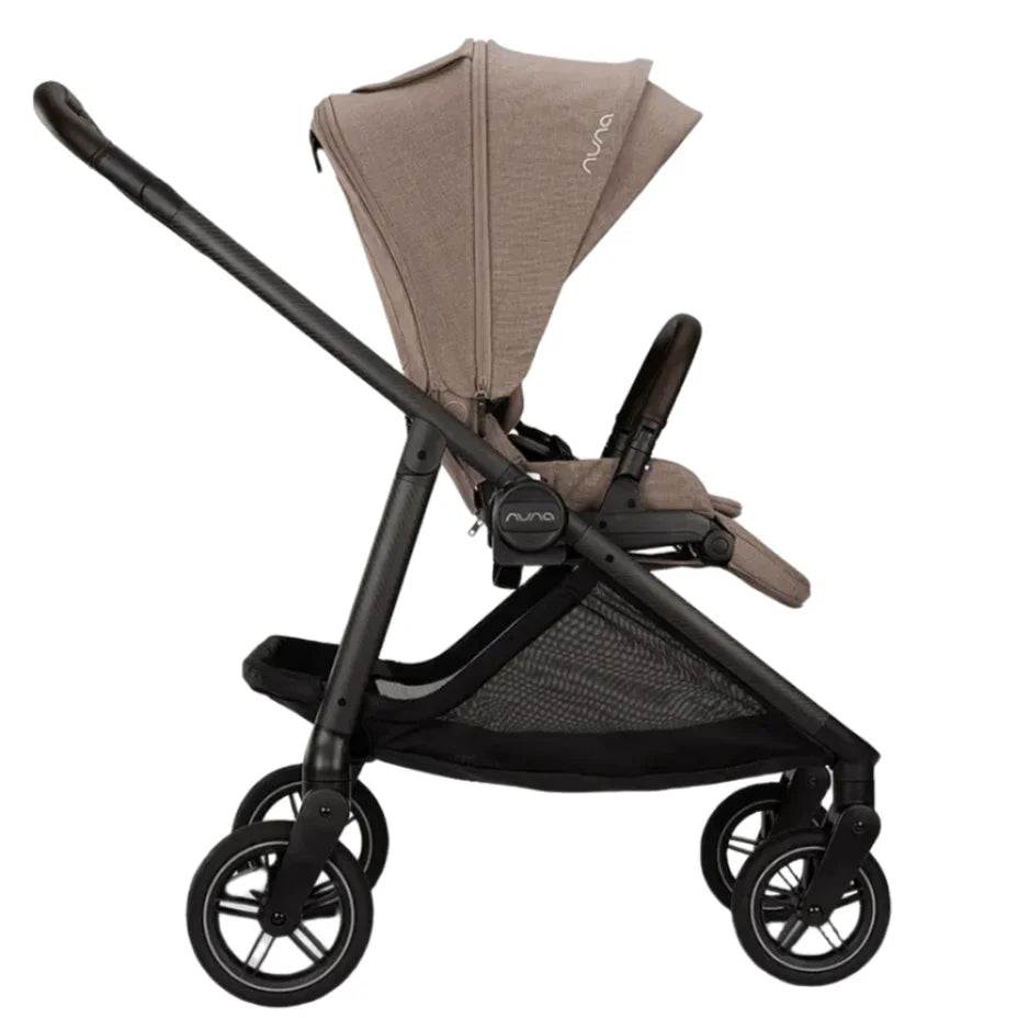 Side view of the gray Nuna SWIV Stroller by Nuna, boasting a black frame, 360-degree swivel stroller wheels, a canopy, a footrest, and a spacious under-seat storage basket.