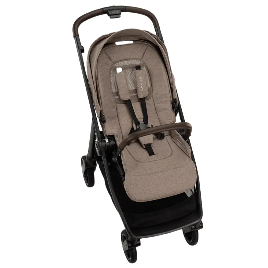 The Nuna SWIV Stroller by Nuna features a brown and black design with a padded seat, harness system, and front guard. It is equipped with four wheels that offer 360-degree swivel for easy maneuverability and includes a handlebar for effortless pushing.