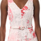 A person wears the Monique Lhuillier Rose Printed Lace Midi Dress—an elegant sleeveless white dress with pink and red floral patterns, crafted from guipure lace and finished with a matching waist belt.