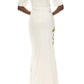 A person wearing the Monique Lhuillier Iris Bouquet Gown stands facing away from the camera against a white background. The fitted, floor-length floral gown features short sleeves and creates an elegant silhouette.