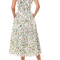 A woman stands with hands in pockets, wearing a Monique Lhuillier Ivy Bloom Short Sleeve Floral Day Dress and beige high heels.