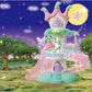 A whimsical, pastel-colored Calico Critters Fairytale Tower stands in a glowing, magical meadow at night, adorned with flower-themed furniture. Three fairies—including a radiant Nectar Fairy—flutter beneath the full moon in the starry sky.