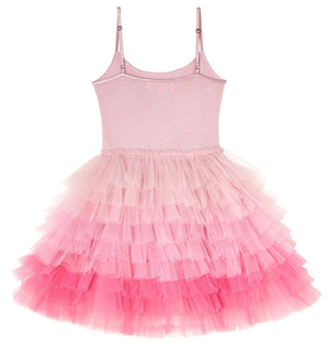 The Girls’ Angelina Tutu Dress by Tutu du Monde features a sleeveless design with adjustable straps and a layered ombre tutu skirt in shades of light pink to bright pink.