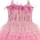 The Girls’ Angelina Tutu Dress by Tutu du Monde features thin straps, feather trim on the bodice, vertical sequins, radiant rhinestones, and a layered tulle skirt that cascades in ombré ruffles from light to dark pink—perfectly embodying the elegance of a feather-trimmed dress.