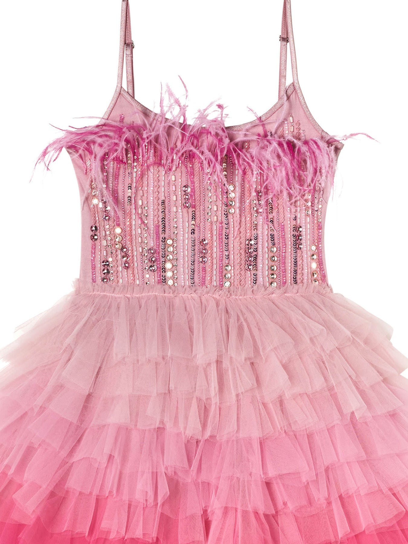The Girls’ Angelina Tutu Dress by Tutu du Monde features thin straps, feather trim on the bodice, vertical sequins, radiant rhinestones, and a layered tulle skirt that cascades in ombré ruffles from light to dark pink—perfectly embodying the elegance of a feather-trimmed dress.