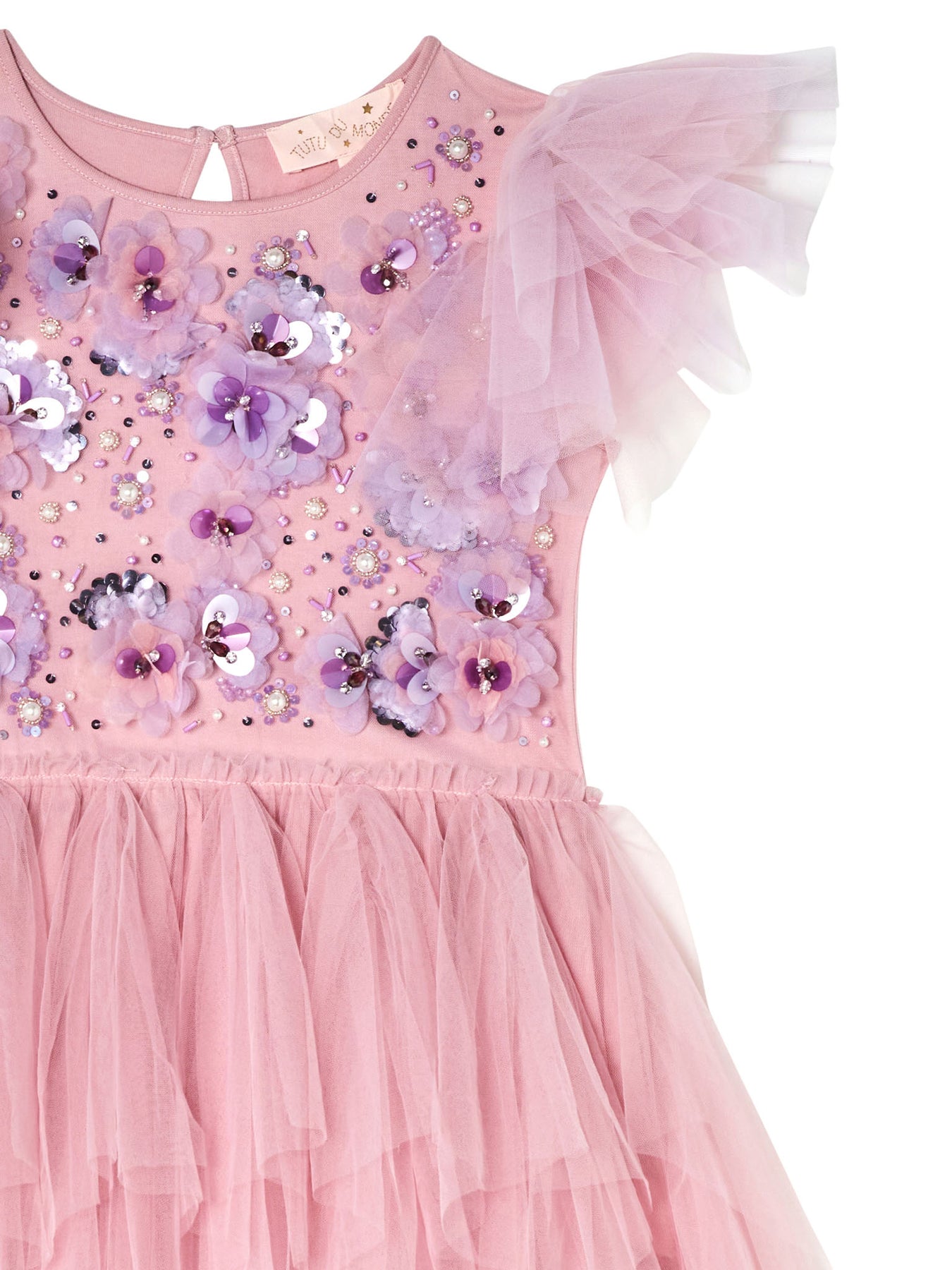 Close-up of the Girls’ Sparkle in Bloom Tutu Dress by Tutu du Monde, featuring a pink layered tulle skirt in Fairy Floss Mix, adorned with floral embellishments, sequins, and an asymmetric ruffled tulle sleeve.