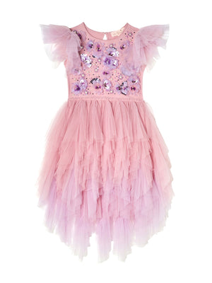 The Girls’ Sparkle in Bloom Tutu Dress by Tutu du Monde captivates with its pink ruffled tulle design in the whimsical Fairy Floss Mix, featuring short, layered sleeves and intricate 3D floral appliqué on the bodice, elegantly set against a white background.