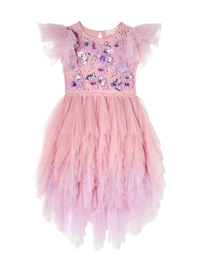 The Girls’ Sparkle in Bloom Tutu Dress by Tutu du Monde captivates with its pink ruffled tulle design in the whimsical Fairy Floss Mix, featuring short, layered sleeves and intricate 3D floral appliqué on the bodice, elegantly set against a white background.