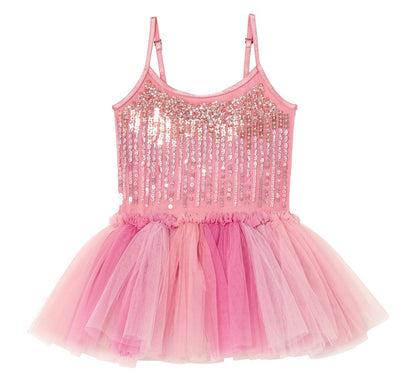 The Girls’ Bebe Shirley Sparkle Tutu by Tutu du Monde is a peach blush tutu dress for little girls, featuring a pink sleeveless design with a sequined bodice, delicate thin straps, and a layered tulle skirt in various shades of pink.