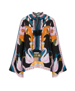 The Lug Von Siga Tess Top is a vibrant blouse adorned with swans, flowers, and geometric patterns, complemented by ruffled accents on the front and collar.