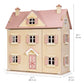 The Alouette House by Tender Leaf Toys is a wooden plywood dolls house featuring a pink roof, decorated shutters, and door, and measures 29" (74 cm) tall, 27" (68.5 cm) wide, and 14.5" (37 cm) deep.
