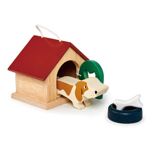 The Pet Dog Set by Tender Leaf Toys includes a charming brown and white basset hound figurine, a green bowl, and a white bone beside a cozy dog bed—perfect for imaginative play in wooden dolls houses.