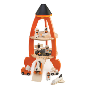 The Tender Leaf Toys Cosmic Rocket Set is a wooden playset with three levels, complete with small astronaut figures, vehicles, and space-themed accessories thoughtfully arranged around and inside the rocket—an engaging astronomy toy designed to inspire imaginative adventures.