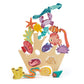 The Stacking Coral Reef by Tender Leaf Toys is a charming wooden stacking toy with vibrant sea creatures—such as a crab, fish, and starfish—arranged on a light wood base designed to resemble a shipwreck. This delightful under-the-sea toy encourages imaginative play and helps introduce children to ocean life.