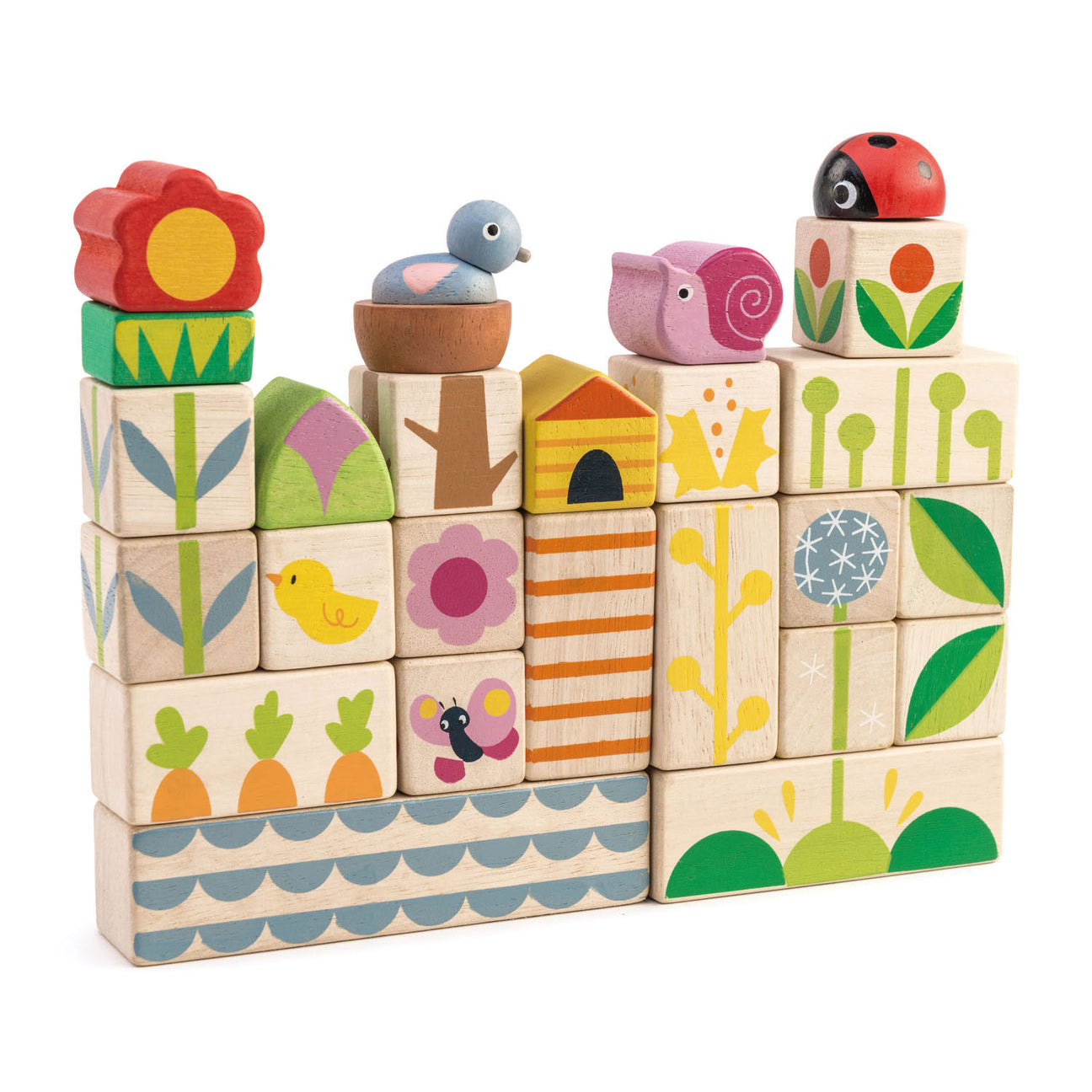 A stack of Garden Blocks by Tender Leaf Toys features colorful wooden pieces adorned with nature-themed illustrations—such as flowers, animals, plants, and patterns—arranged in a rectangular formation. These push and click blocks are designed to enhance hand-eye coordination while introducing children to delightful garden shapes.