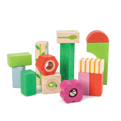 The Tenderleaf Nursery Blocks by Tender Leaf Toys are garden-themed, vibrant wooden building blocks available in various shapes and sizes such as rectangles, squares, and a flower shape. These blocks encourage hand-eye coordination and are ideal for any nursery.