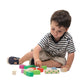 A child sits on the floor, playing with Tenderleaf Nursery Blocks by Tender Leaf Toys, which are colorful and garden-themed to enhance hand-eye coordination.