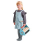 A little girl in overalls holding a Tenderleaf Tap Tap Tool Box.