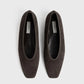 A pair of Toteme Minimalist Suede Ballerinas in dark brown with square toes, made in Spain, shown from above on a plain white background.