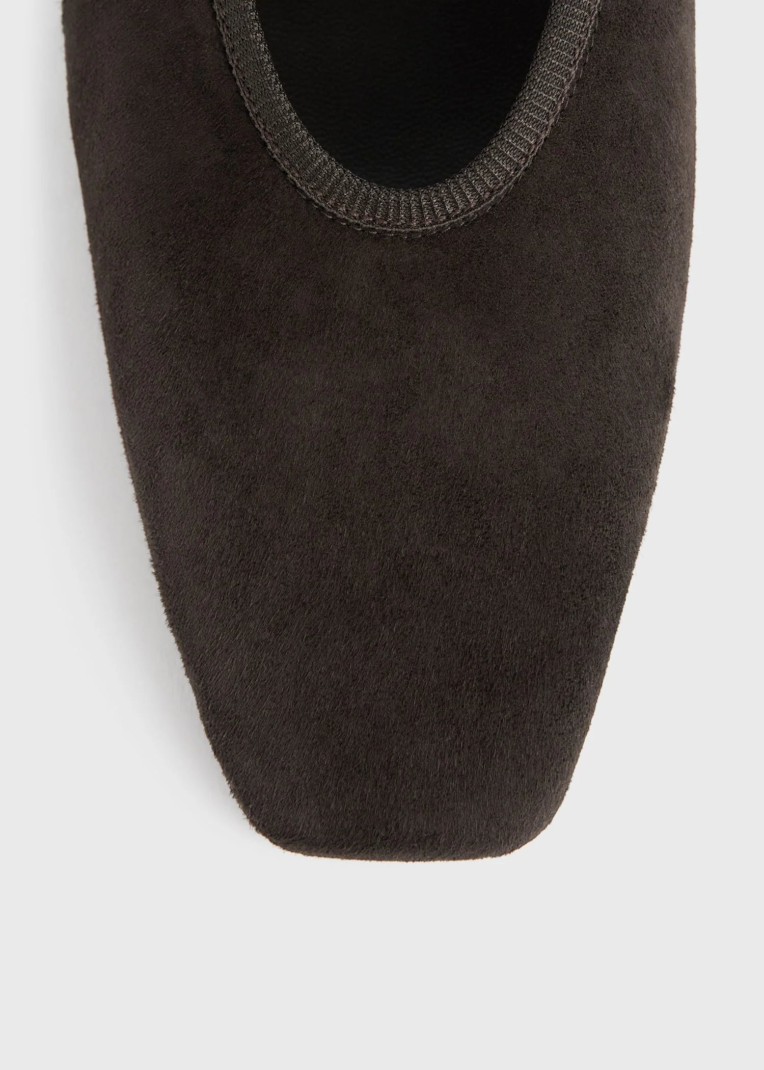 Close-up of Toteme's Minimalist Suede Ballerinas in dark brown, featuring a square toe and crafted in Spain, displayed against a plain light background.