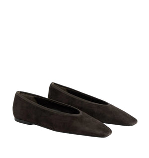 The Toteme Minimalist Suede Ballerinas, in dark brown with a low heel and rounded square toe, made in Spain, are shown against a white background.