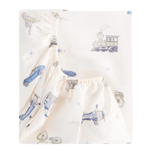 The Gooselings Transit Treasures Crib Sheet is cream-colored and extra soft, featuring vintage cars, trains, bicycles, and airplanes in blue and gray; made from OEKO-TEX certified cotton sateen for comfortable peace of mind.