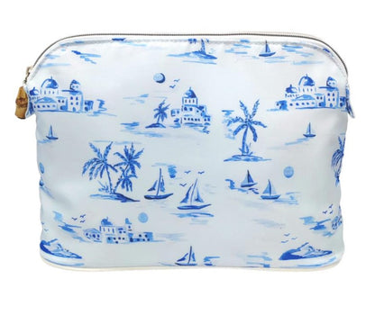 White custom printed twill TRVL Bag from the Cote D'Azur Collection with blue nautical and tropical prints, including sailboats, palm trees, and buildings, with a dome top zip closure by TRVL Design.