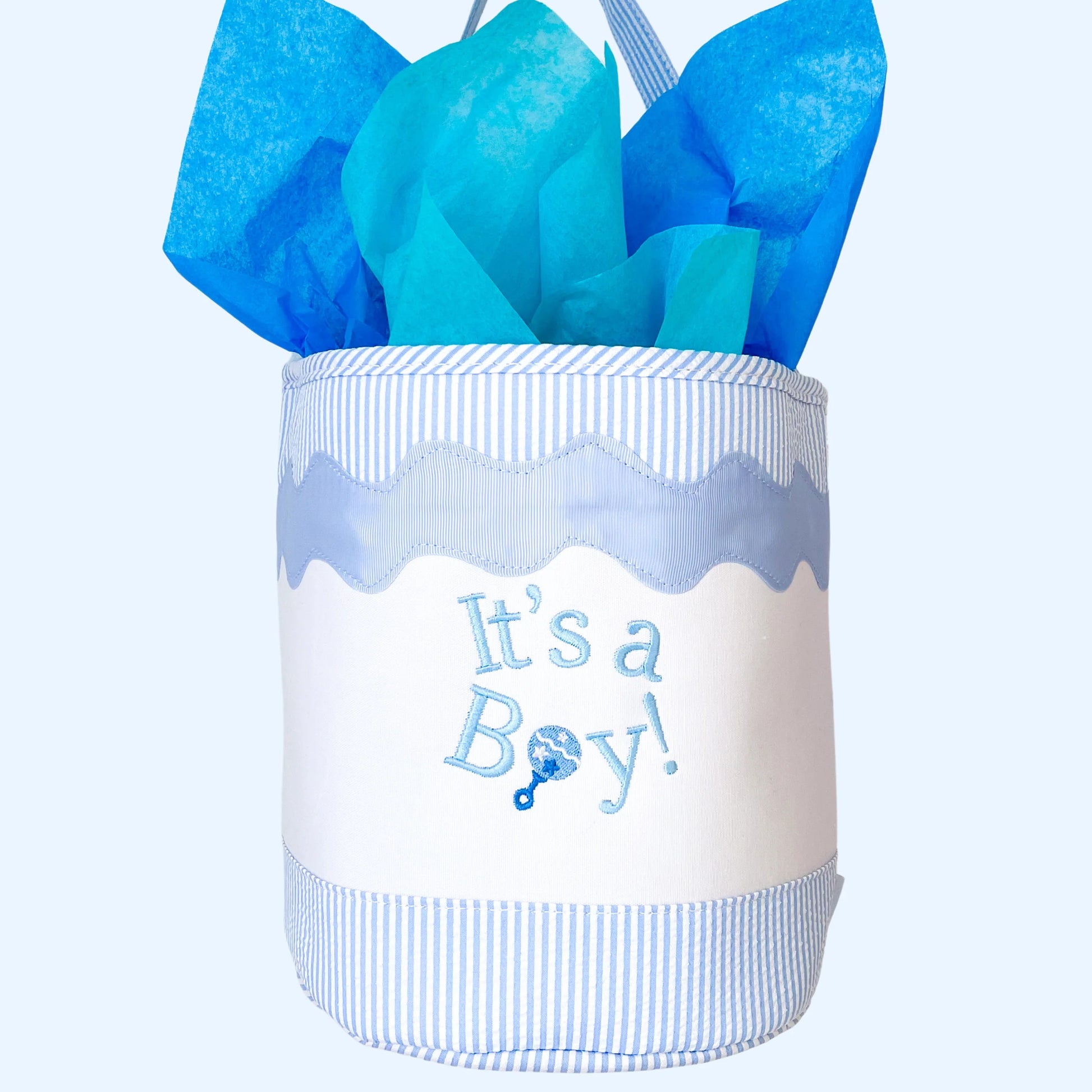 The Bits & Bows "It's a Boy Tote" features blue and white stripes, blue tissue paper, and "It's a Boy!" on the front—ideal as a sustainable toy tote or gift bag for any celebration.