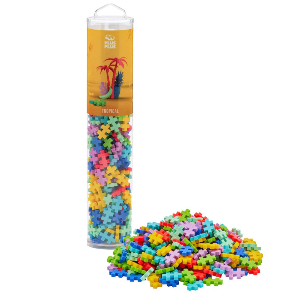 A clear tube labeled "Plus Plus Tube - 240 Piece Tropical Mix" from Plus Plus is packed with colorful interlocking pieces for creative play and fine motor skill development, with extra pieces displayed in front of the tube.