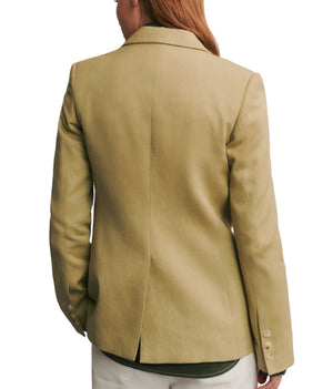 A person with long hair wearing the TWP Husband Linen Jacket in beige, seen from the back.