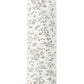 The Quincy Mae Bamboo Swaddle is a soft bamboo fabric baby wrap, white with a pattern of small, scattered flowers and leaves in muted colors.