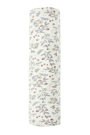 The Quincy Mae Bamboo Swaddle is a soft bamboo fabric baby wrap, white with a pattern of small, scattered flowers and leaves in muted colors.