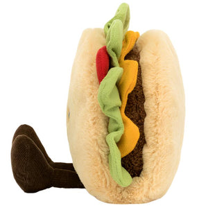 The Jellycat Amuseables Taco is a plush toy by Jellycat, designed to resemble a hamburger with a bun, lettuce, tomato, cheese, and patty. It also features brown legs and has a soft taco shell similar to the Amuseables Taco.