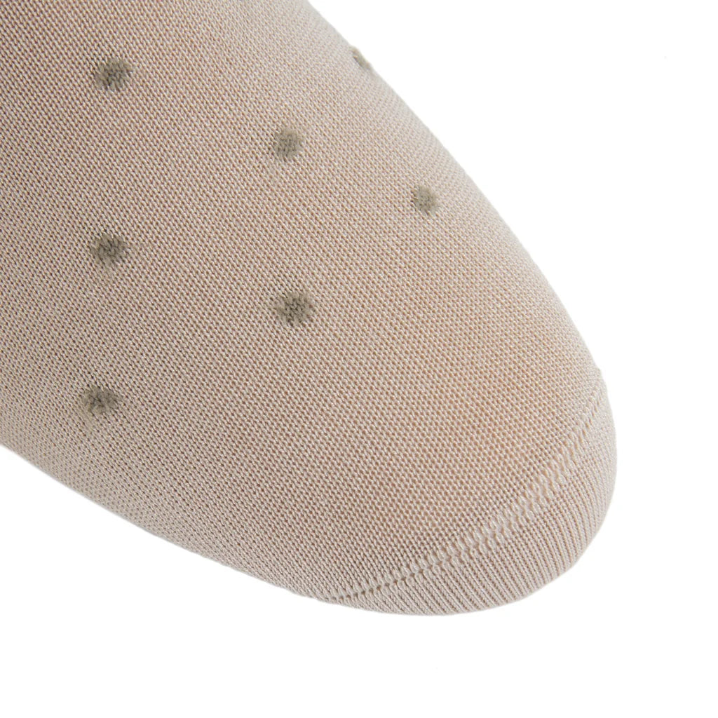 Close-up of the Dot Cotton Mid Calf Sock by Dapper Classics, featuring beige fabric with a fine knit texture and evenly spaced small dark dots—perfect for anyone looking for refined men’s dress socks with a subtle dot pattern.