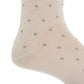 Close-up of a light beige Dapper Classics Dot Cotton Mid Calf Sock featuring small, evenly spaced gray polka dots, highlighting the heel and ankle area—an elegant option for men’s dress socks.