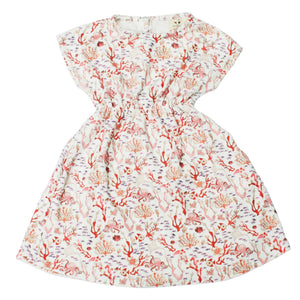 The Delphine Dress by Timo & Violet is a playful summer dress for baby girls and girls featuring short sleeves, organic cotton, and a vibrant Rosy Coral Reef print with a gathered waist and round neckline.