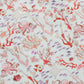 Timo & Violet’s Baby Girls' and Girls' The Delphine Dress features white fabric with Rosy Coral Reef print—red coral, pink octopuses, and purple fish—perfect for a vibrant summer look.