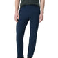 A person in a dark short-sleeve shirt, Rag & Bone Tapered Nylon-Blend Trouser (classic fit, navy), and black sneakers stands against a plain background.