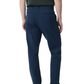 A person wearing Rag & Bone Tapered Nylon-Blend Trouser in navy, a dark shirt, and black sneakers stands facing away against a white background.
