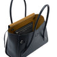 The Proenza Schouler Tate Bag is an open black leather handbag with two handles, a luxurious tan interior, and a zippered inside pocket.