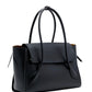 The Proenza Schouler Tate Bag is a black leather handbag with long handles, a front flap closure, and a structured design featuring slightly angled sides.