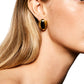 Close-up of a person with long blonde hair showcasing the LIÉ STUDIO Camille Earrings by Lie Studio, intricately crafted and 18-carat gold plated, adding a touch of classic elegance.