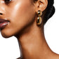 Close-up of a person wearing the LIÉ STUDIO Klara Earrings by Lie Studio. They have a smooth complexion and their hair is pulled back, creating an antique silhouette against the white backdrop.