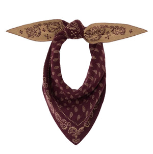 Introducing The Wild Rag by Guest in Residence—a cashmere bandana featuring a classic maroon paisley pattern, knotted to form a triangular silhouette with pointed ends. Inspired by our best-selling scarf style, this luxurious accessory effortlessly blends timeless design with exceptional comfort.