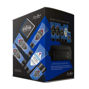 Box featuring Jack Black’s “The Jetsetter” travel grooming kit with five toiletries—including a daily facial cleanser and face moisturizer—in blue-black tubes, plus an exclusive black travel bag, displayed on a white background.