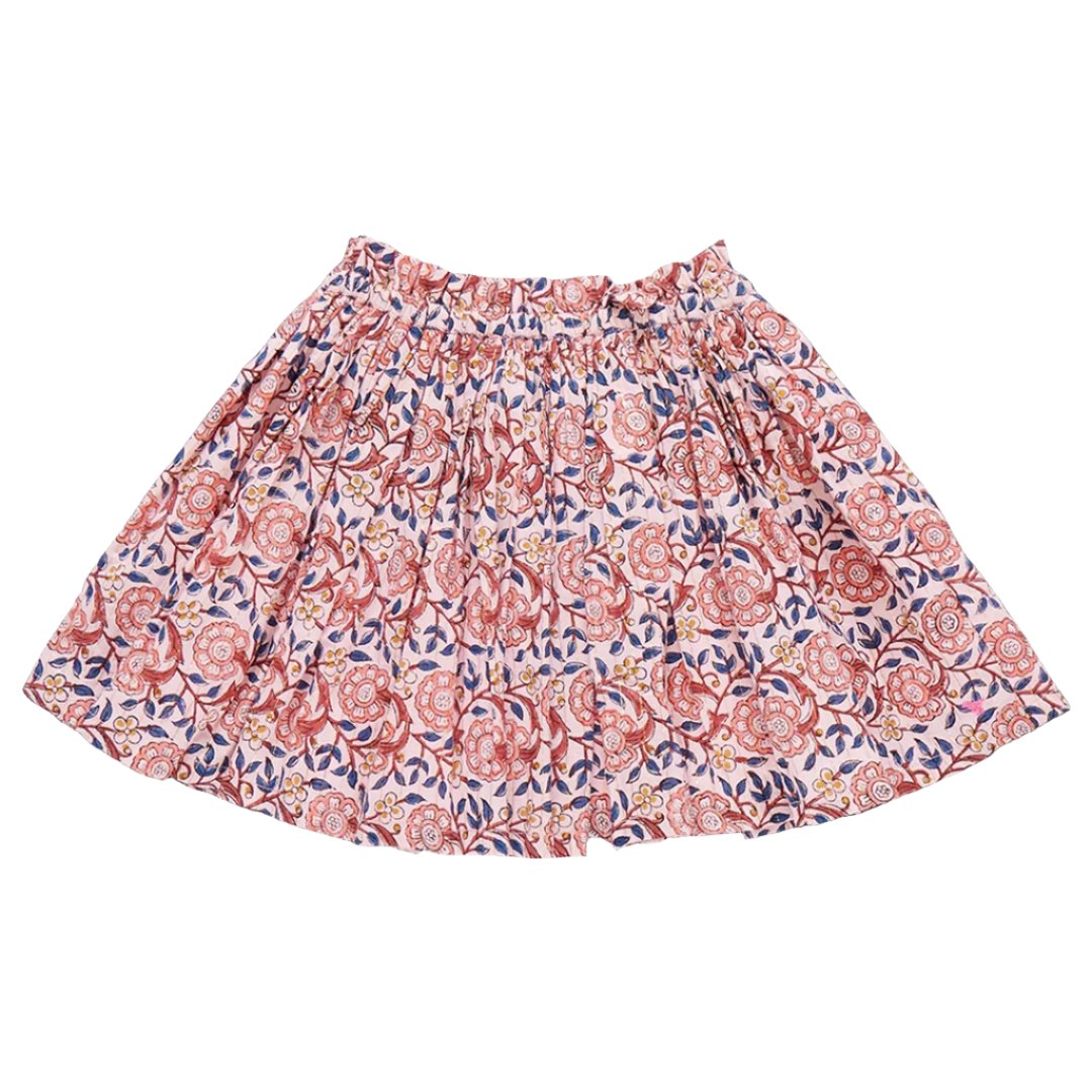 The Pink Chicken Girls' Theodore Skirt from Pink Chicken is a knee-length skirt featuring a colorful floral pattern in shades of red, pink, blue, and white. It boasts an elastic ruffle waist adorned with shimmery rose gold thread.