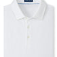 The Excursionist Flex Polo by Peter Millar is a white folded shirt made from natural fibers, featuring a collar and three buttons for classic style. The brand's label is elegantly stitched inside the neckline, offering stretch mobility for enhanced comfort.