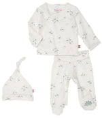 The Magnetic Me Tiny Diny Kimono Set features a white, long-sleeve shirt, pants, and a hat adorned with small dinosaur prints. Made from organic cotton and designed with SewSafe™ magnetic closures for easy changes, this newborn kimono set from Magnetic Me ensures comfort and safety for your little one.