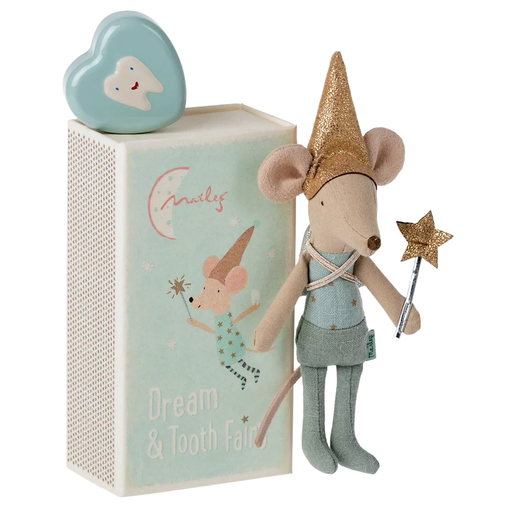 A Maileg Tooth Fairy Mouse in a blue matchbox, adorned with a gold hat and holding a wand, stands next to a mint-colored box featuring the "Dream & Tooth Fairy" text and an illustration of a mouse. On top sits a tooth-shaped container, perfect for sweet dreams.