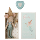 A small plush mouse by Maileg, dressed as a tooth fairy with a glittery hat and wings, rests in a box labeled "Maileg Tooth Fairy Mouse in Matchbox, Blue," perfect for holding a special tooth box. A heart-shaped item is placed lovingly above the box, creating an enchanting scene ideal for sweet dreams.